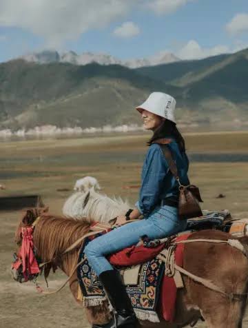 Horse riding across the grassland.
